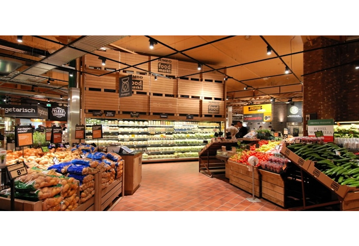 Studio Königshausen's retail design for Jumbo Supermarket in Breda, The Netherlands, aims to enhance the food shopping experience. Jumbo, a family-owned supermarket chain, wanted to elevate food preparation and enjoyment in their stores while maintaining affordability and convenience.